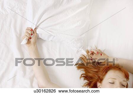 woman holding on to pillow in bed View Large Photo Image Stock Photograph - woman holding on to pillow in bed. Fotosearch