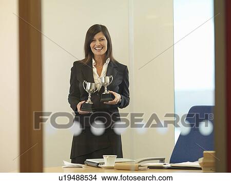 Woman holding trophies View Large Photo Image Picture - Woman holding trophies. Fotosearch