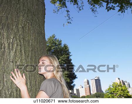 Woman hugging a tree View Large Photo Image Stock Image - Woman hugging a tree. Fotosearch