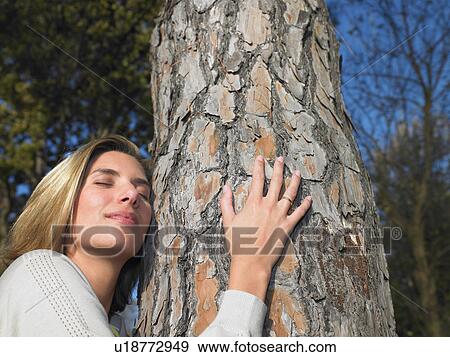 Stock Photo - Woman hugging a tree. Fotosearch