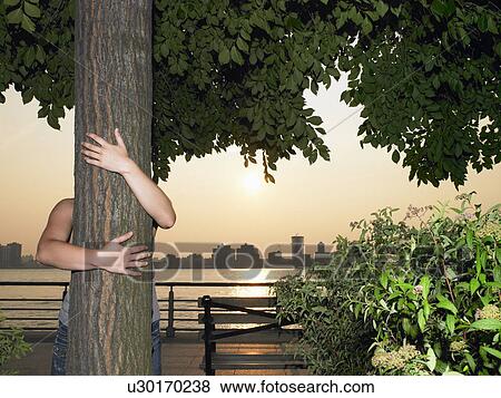 Woman hugging a tree View Large Photo Image Stock Photo - Woman hugging a tree. Fotosearch