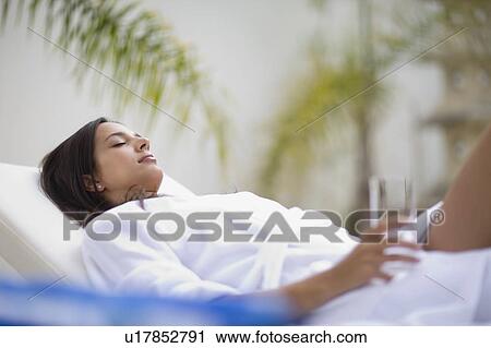 Stock Image - Woman in a spa on deckchair. Fotosearch