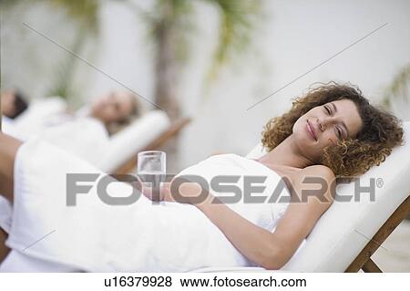 Stock Photo - Woman in a spa on deckchair. Fotosearch