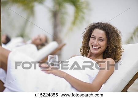 Stock Photography - Woman in a spa on deckchair. Fotosearch