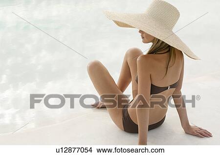 Woman in a swimsuit and large hat View Large Photo Image Picture - Woman in a swimsuit and large hat. Fotosearch