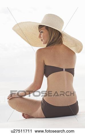 Woman in a swimsuit and large hat View Large Photo Image Stock Image - Woman in a swimsuit and large hat. Fotosearch