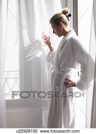 Woman in bath robe by the window View Large Photo Image Stock Image - Woman in bath robe by the window. Fotosearch