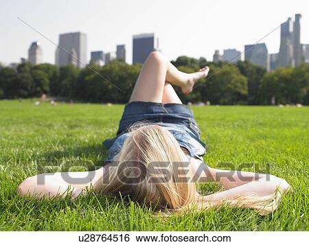 Woman in central park, enjoying the view View Large Photo Image Stock Photograph - Woman in central park, enjoying the view. Fotosearch