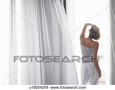 Woman in her pyjamas, on the balcony View Large Photo Image Stock Photo - Woman in her pyjamas, on the balcony. Fotosearch