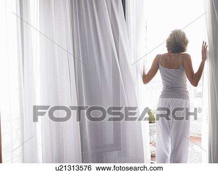Woman in her pyjamas, on the balcony View Large Photo Image Stock Photograph - Woman in her pyjamas, on the balcony. Fotosearch