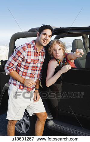 Woman in jeep giving man directions View Large Photo Image Stock Photo - Woman in jeep giving man directions. Fotosearch