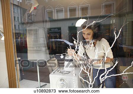 woman in shop window behind tree View Large Photo Image Stock Image - woman in shop window behind tree. Fotosearch