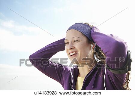 Woman in sports clothes smiling outside View Large Photo Image Stock Photo - Woman in sports clothes smiling outside. Fotosearch