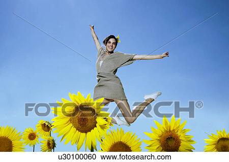 Woman in sunflower field View Large Photo Image Stock Image - Woman in sunflower field. Fotosearch