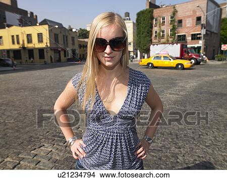 Picture - Woman in the street, looking at camera. Fotosearch