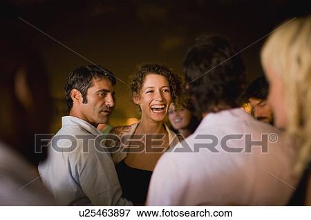 Woman laughing at party at night View Large Photo Image Stock Photo - Woman laughing at party at night. Fotosearch