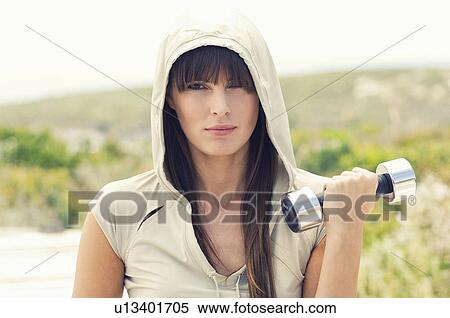 Stock Photography - Woman lifting weights. Fotosearch