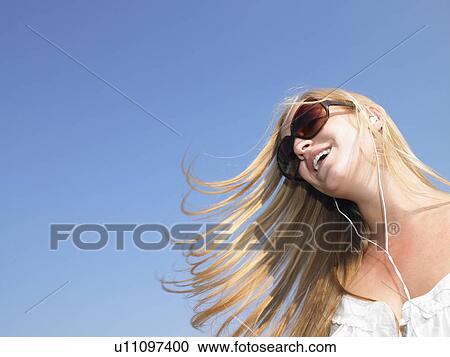 Woman listening to her mp3 player View Large Photo Image Stock Image - Woman listening to her mp3 player. Fotosearch