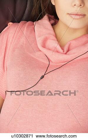 Stock Image - Woman listening to music cropped shot. Fotosearch