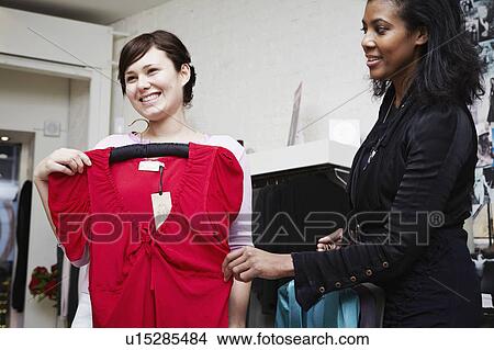 Woman looking at dresses View Large Photo Image Picture - Woman looking at dresses. Fotosearch