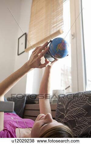 Woman looking at globe View Large Photo Image Stock Photo - Woman looking at globe. Fotosearch