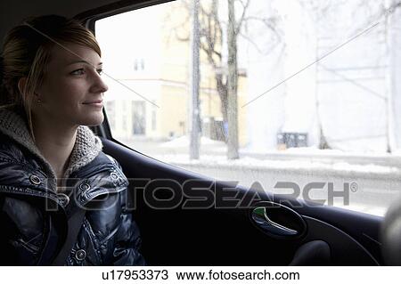 Woman looking out of car window View Large Photo Image Stock Image - Woman looking out of car window. Fotosearch