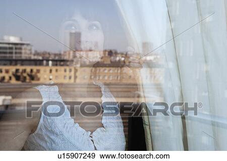 Stock Photo - Woman looking out window. Fotosearch