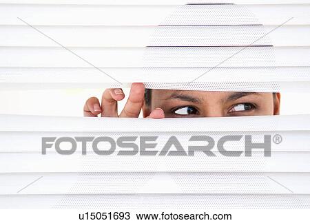 Woman looks through blinds View Large Photo Image Stock Image - Woman looks through blinds. Fotosearch