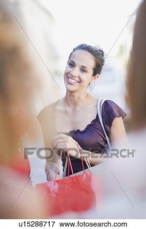 Stock Photo - Woman meeting her friends in the city. Fotosearch