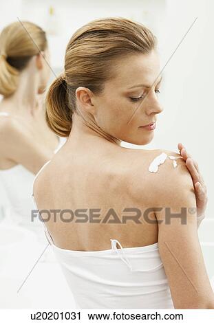 Woman moisturizing her shoulders View Large Photo Image Stock Image - Woman moisturizing her shoulders. Fotosearch