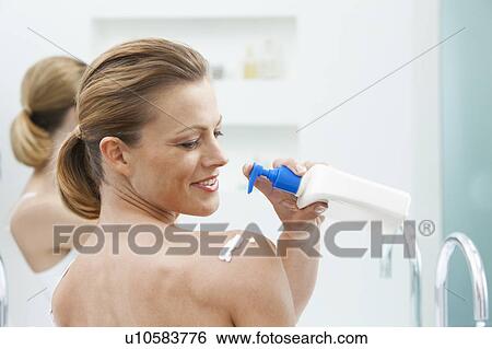 Woman moisturizing her shoulders View Large Photo Image Stock Photograph - Woman moisturizing her shoulders. Fotosearch