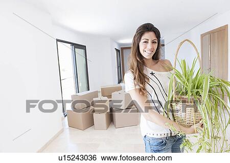 Woman moving into new home View Large Photo Image Stock Photograph - Woman moving into new home. Fotosearch
