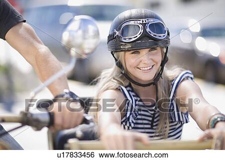 Stock Photograph - Woman on a motorbike. Fotosearch