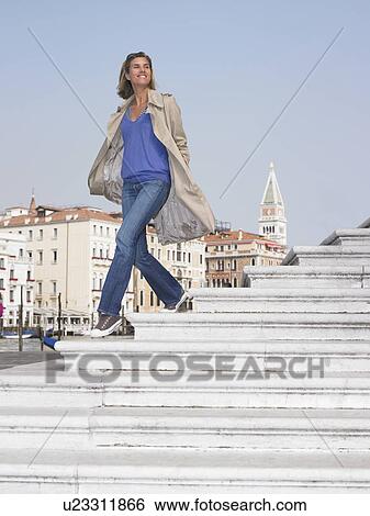 Woman on stairs by the marina View Large Photo Image Stock Photograph - Woman on stairs by the marina. Fotosearch