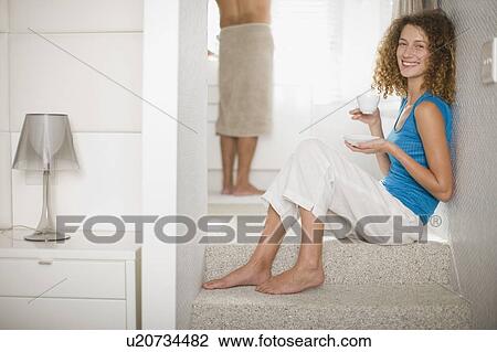 Woman on steps drinking coffee View Large Photo Image Stock Image - Woman on steps drinking coffee. Fotosearch