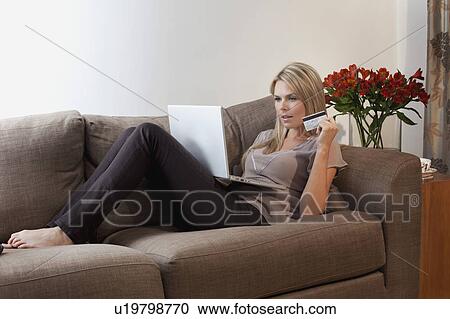 Stock Image - Woman Online shopping from home. Fotosearch