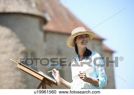 Woman painting a picture, outdoors View Large Photo Image Stock Image - Woman painting a picture, outdoors. Fotosearch