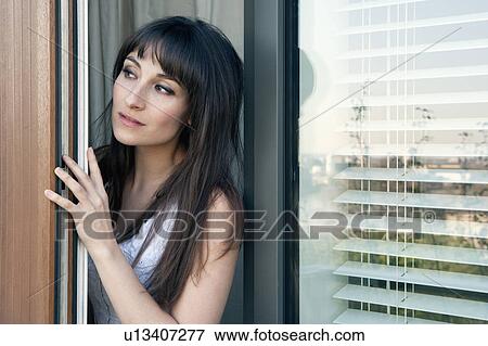 Woman peeking out of doorway View Large Photo Image Stock Photo - Woman peeking out of doorway. Fotosearch