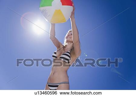 Woman playing with beach ball View Large Photo Image Stock Photograph - Woman playing with beach ball. Fotosearch