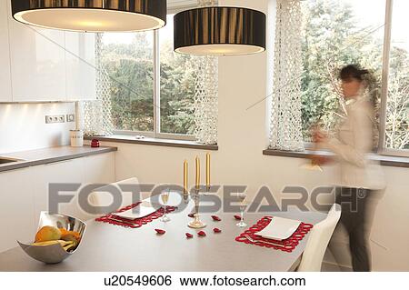 Woman preparing a candle light dinner View Large Photo Image Stock Photograph - Woman preparing a candle light dinner. Fotosearch