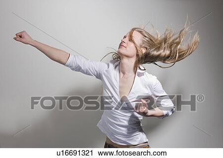 Stock Image - Woman punching in the air. Fotosearch