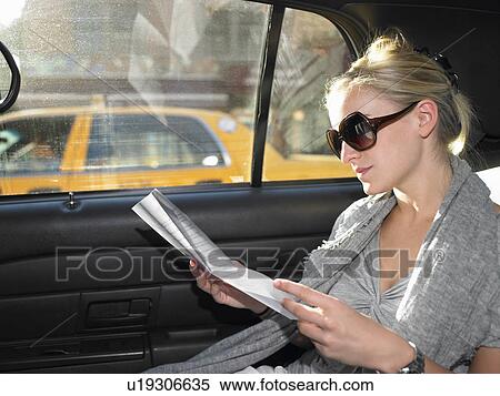 Woman reading a letter in a taxi View Large Photo Image Stock Photography - Woman reading a letter in a taxi. Fotosearch