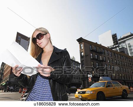 Stock Photo - Woman reading a letter in the street. Fotosearch