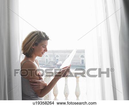 Woman reading a letter View Large Photo Image Picture - Woman reading a letter. Fotosearch