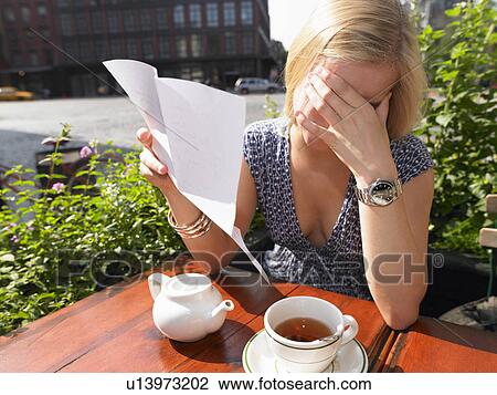 Woman reading a sad letter View Large Photo Image Stock Image - Woman reading a sad letter. Fotosearch
