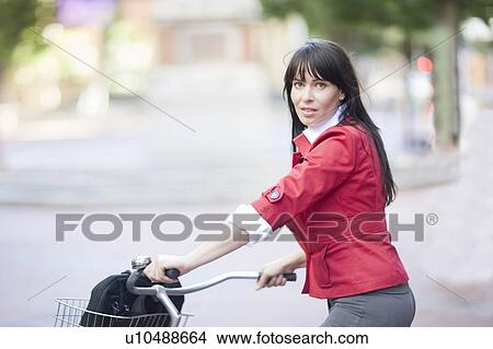 Picture - Woman riding a bicycle. Fotosearch