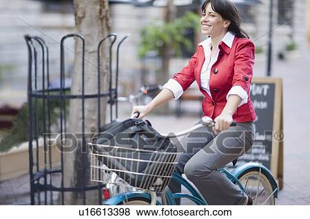 Woman riding a bicycle View Large Photo Image Stock Photo - Woman riding a bicycle. Fotosearch