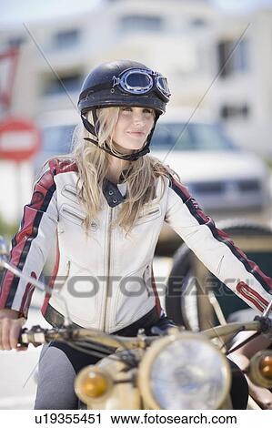 Woman riding a motorbike View Large Photo Image Stock Image - Woman riding a motorbike. Fotosearch