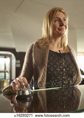 Woman ringin a hotel porters bell View Large Photo Image Stock Image - Woman ringin a hotel porters bell. Fotosearch
