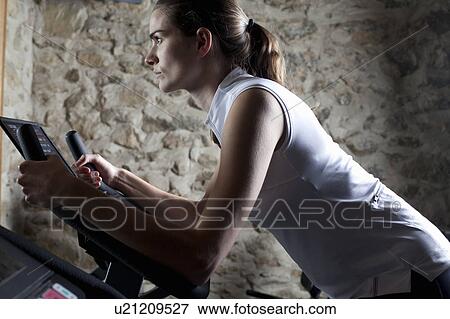 Stock Photo - woman running on pebble beach. Fotosearch